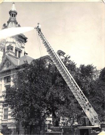 Firefighter at Top of Ladder